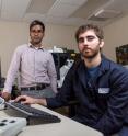 Principal investigator Amit Reddi and lead researcher David Hanna observe an image of a baker's yeast cell taken under a microscope as it lights up green from the tailor made fluorescent ratiometric sensor they have infused it with.