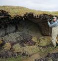 Allen Bondurant, U. Alaska Fairbanks, measures the soil depth to permafrost along a thermokarst lake shore in northern Alaska.