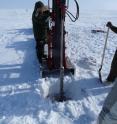 ORNL's Kenneth Lowe operates a hydraulic drill to collect frozen soil cores from Barrow for incubation experiments.