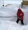 University of Kansas professor David Besson pulling hardware out of a hole with a previously-deployed antenna.