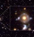 This is the Eye of Horus in pseudo color. Enlarged image to the right (field of view of 23 arcseconds x 19 arcseconds) show two arcs/rings with different colors. The inner arc has a reddish hue, while the outer arc has a blue tint. These arcs are lensed images of the two background galaxies. There are blobs in and around the arcs/rings, which are also the lensed images of those background galaxies. The yellow-ish object at the center is a massive galaxy at z = 0.79 (distance 7 billion light years), which bends the light from the two background galaxies. The wide field image in the background is here. Enlarged image of the Eye of Horus is here and the image with labels is here.
