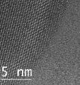 This is an atomic view of liquid and solid gallium coexisting in a single nanoparticle taken by a transmission electron microscope. The circular shape on the left-hand side shows gallium atoms in an organized, crystalline, solid structure, while the atoms on the right are in liquid form, showing no organized structure at all.