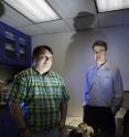 Morgan Churchill, Ph.D., left, and Jonathan Geisler, Ph.D., right, of New York Institute of Technology College of Osteopathic Medicine with the 27-million-year-old fossil skull of <i>Echonevator sandersi</i> ("Echo Hunter")