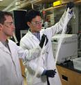 Georgia Tech Assistant Professor Ryan Lively (left) and Postdoctoral Fellow Dong-Yeun Koh hold bundles of hollow polymer fibers that serve as precursors for the carbon membrane fiber used to separate alkyl aromatic chemicals.