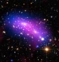 Massive galaxy cluster MACS J0416 seen in X-rays (blue), visible light (red, green, and blue), and radio light (pink).