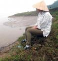 High concentrations of arsenic are making their way from the Red River into aquifers near Hanoi, Vietnam, a new study shows. Mason Stahl tests water at the river's edge where sediment is being deposited.