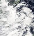 On Sept. 12 NASA's Aqua satellite passed over Tropical Depression 19W in the South China Sea and captured this visible image of the storm already moving over Vietnam (left).