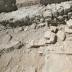View of the remnants of the podium, the temple's façade and some steps. The long wall in the background belongs to the church whose foundations were built on the remains of the temple.