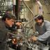 University of Utah chemistry Professor Scott Anderson and doctoral student Bill Kaden work on the elaborate apparatus they use to produce and study catalysts, which are substances that speed chemical reactions without being consumed. The world economy depends on catalysts, and the Utah research is aimed at making cheaper, more efficient catalysts, which could improve energy production and reduce emissions of Earth-warming gases.
