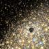 An artist's concept of stars moving in the central regions of a giant elliptical galaxy that harbors a supermassive black hole.