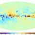 The sky map of the Faraday effect caused by the magnetic fields of the Milky Way. Red and blue colors indicate regions of the sky where the magnetic field points toward and away from the observer, respectively. The band of the Milky Way (the plane of the Galactic disk) extends horizontally in this panoramic view. The center of the Milky Way lies in the middle of the image. The North celestial pole is at the top left and the South Pole is at the bottom right.