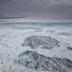 These icebergs recently calved from the front of the north branch of Jakobshavn Isbrae, a large outlet glacier that drains 6.5 percent of the Greenland ice sheet. The fact that they are upright, indicated by their dirty and crevassed surfaces, suggests they calved from the floating end of a glacier.