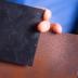 A graphene-based coating under development at UB keeps a piece of steel rust-free (foreground), in stark comparison with a rusted sheet of steel (background).