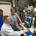 The Visible Nulling Coronagraph (VNC) combines an interferometer with a coronagraph to image and characterize Jovian-size planets. In this photo, Goddard scientists Rick Lyon (foreground) and Udayan Mallik (left), who are joined by Pete Petrone (right), an employee of Sigma Space Corporation in Lanham, Md., are monitoring the progress of wavefront control using the VNC, which is operating inside a vacuum tank.