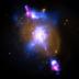 The intense gravity of a supermassive black hole can be tapped to produce immense power in the form of jets moving at millions of miles per hour.  A composite image shows this happening in the galaxy known as 4C+29.30 where X-rays from Chandra (blue) have been combined with optical (gold) and radio (pink) data.  The X-rays trace the location of superheated gas around the black hole, which is estimated to weight 100 million times the mass of our Sun. Some of this material may eventually be consumed by the black hole, and the magnetized, whirlpool of gas near the black hole could in turn, trigger more output to the radio jet. The optical light image shows the stars in this galaxy.  A torus of gas and dust surrounds the black hole and blocks most of the optical light coming from there.  Because of this, astronomers refer to this type of source as a hidden or buried black hole.