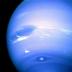 This is an image from the Voyager 2 flyby of Neptune in August 1989 (NASA). In the middle is the Great Dark Spot, accompanied by bright, white clouds that undergo rapid changes in appearance. To the south of the Great Dark Spot is the bright feature that Voyager scientists nicknamed "Scooter." Still farther south is the feature called "Dark Spot 2," which has a bright core. As each feature moves eastward at a different velocity, they are rarely aligned this way. Wind velocities near the equator are westward, reaching 1300 km/h, while those at higher latitudes are eastward, peaking at 900 km/h.