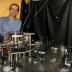 A new window into the nature of the universe may be possible with a device proposed by scientists at the University of Nevada, Reno and Stanford University that would detect elusive gravity waves from the other end of the cosmos. Their paper describing the device and process was published in the prestigious physics journal <i>Physical Review Letters</i>. Andrew Geraci, assistant professor in the University of Nevada, Reno physics department, demonstrates an apparatus that is of part of an experiment that uses similar technology to his gravitational wave detector. This equipment uses levitated nanospheres in an optical trap for investigations of the gravitational force at the micron length scale, where some theories in high-energy physics predicts there will be a deviation from the Newtonian inverse square law of gravitation.