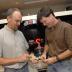 UT Austin professors John Kappelman and Richard Ketcham examine casts of Lucy while scanning the original fossil (background).