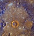 Just after MESSENGER's closest approach to Mercury (200 km above the surface), high-resolution color images of Mercury were obtained (500 meters per pixel). These images help to highlight compositional variations within the crust, both horizontally and vertically.  At the center, a crater 68 km in diameter exposes the stratigraphy of  the region.   Material with higher reflectance and a steeper spectral  
slope (bright orange in this view) is exposed in the ejecta near the crater rim.  This material was most likely excavated from a smooth plains unit that was buried by the lower-reflectance plains unit seen surrounding the crater.  A portion of the crater's central peak exposes material that is lower in reflectance and has a shallower spectral slope (blue in this color scheme); this material was  uplifted by the cratering process from a depth of as much as 10 km.   Similar material that can be seen near the edges of the image represents the degraded rim and ejecta of an ancient basin.
