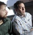 Doctoral student Mark Winter (left) and Andrew Cohen, an assistant 
professor of electrical engineering, examine a color-coded "map" formed 
from tracking stem cell activity.
