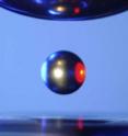 A solid sample hovers in space in NASA's electrostatic levitation chamber. Similar chambers built at Washington University in St. Louis are containerless containers that allow scientists to study materials undergoing phase transitions in the absence of contamination that might alter how the material behaved. A solid sample hovers in space in NASA's electrostatic levitation chamber. Similar chambers built at Washington University in St. Louis are containerless containers that allow scientists to study materials undergoing phase transitions in the absence of contamination that might alter how the material behaved.