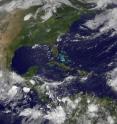 The GOES-13 satellite captured a visible image of System 94L (right) over the Lesser Antilles on June 18 at 7:45 a.m. EDT as a large area of cloudiness, and Tropical Storm Blas is visible in the Eastern Pacific Ocean off the Mexican coast (left).