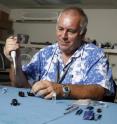 Dr. Aubrey Moore administers a bio-control virus to a rhino beetle.