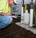 Savannah River National Laboratory personnel take readings at the site of the demonstration of MicroCED microbial consortium for natural cleanup of chlorinated solvents.