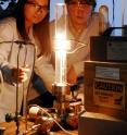 Georgia Tech graduate students Yike Hu and John Hankinson observe a high temperature furnace used to produce graphene on a silicon carbide wafer.