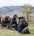 Kessler (on the far left) and her team monitor bustard movements across the wide valley below. Kessler (on the far left) and her team monitor bustard movements across the wide valley below.