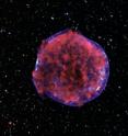 This is a photograph of the Tycho supernova remnant taken by the Chandra X-ray Observatory. Low-energy X-rays (red) in the image show expanding debris from the supernova explosion and high energy X-rays (blue) show the blast wave, a shell of extremely energetic electrons. This is a photograph of the Tycho supernova remnant taken by the Chandra X-ray Observatory. Low-energy X-rays (red) in the image show expanding debris from the supernova explosion and high energy X-rays (blue) show the blast wave, a shell of extremely energetic electrons.