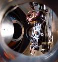 A view inside the photoemission chamber, "Hydra," shows the entry point for one time-of-flight electron spectrometer (on the left, opposite the larger open round hole), as well as a second time-of-flight electron spectrometer (on the left front side looking toward the sample, which is a round silver crystal covered by an ultrathin layer of nickel oxide).