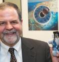 Brad Bushman, professor of communication and psychology at Ohio State University, holds one of the voodoo dolls used in the study.