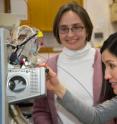 In this image, Elizabeth Kujawinski, left, and her colleague Melissa Soule monitor a mass spectrometer.