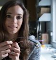 Rice University research scientist Francesca Mirri holds a standard coaxial data cable (bottom) and a new cable with an outer conductor of carbon nanotubes. Replacing the braided metal outer conductor with a conductive nanotube coating makes the cable 50 percent lighter, Mirri said.