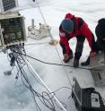 Researchers service one of PROMICE's automatic weather stations on the Greenland ice sheet that was used in the study. Researchers service one of PROMICE's automatic weather stations on the Greenland ice sheet that was used in the study.
