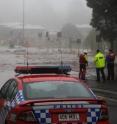 Emergency responders discuss options for rescuing a woman trapped on the roof of her car in flood waters during the 2010-2011 Queensland floods in Australia.