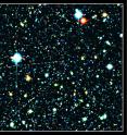 This is a color composite image of a portion of the Subaru XMM-Newton Deep Survey Field. The red galaxy at the center of the image is the most distant galaxy, SXDF-NB1006-2.