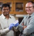 Suprem Das holds graphene electronics printed on a sheet of paper. Das and Jonathan Claussen, right, are using lasers to treat the printed graphene electronics. The process improves conductivity and enables flexible, wearable and low-cost electronics.